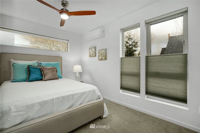 a bedroom with a bed and a mirror