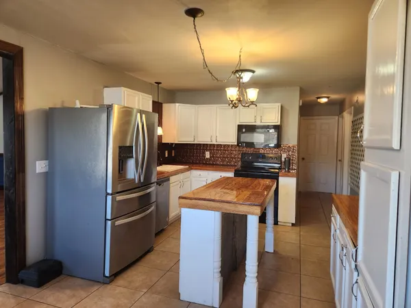 a kitchen with refrigerator a sink and cabinets