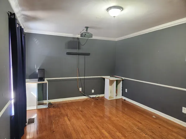 a view of a room with wooden floor