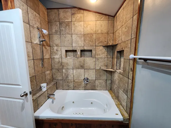 a bathroom with a tub and shower