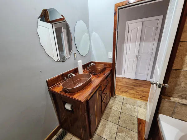 a bathroom with a sink a mirror and vanity
