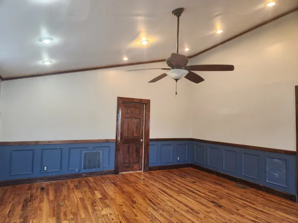 a view of an empty room and wooden floor