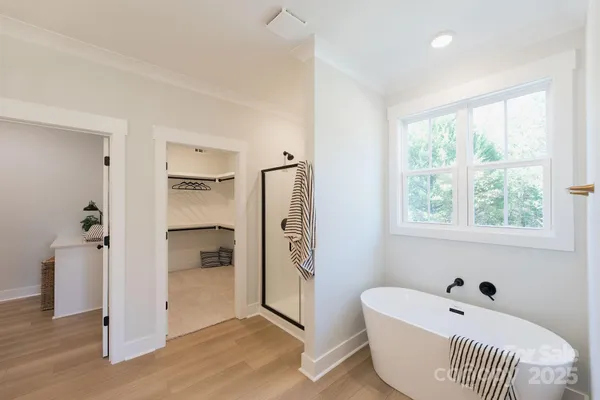 a bathroom with a bathtub and a shower
