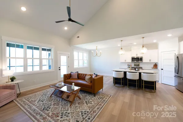a living room with furniture a rug and a window
