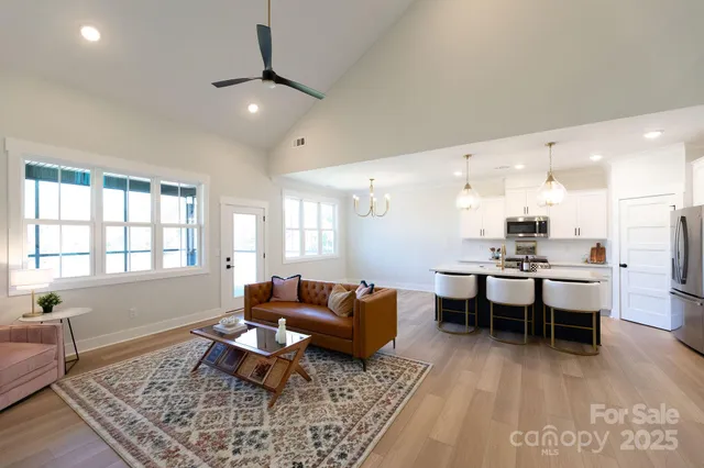 a living room with furniture a rug and a window