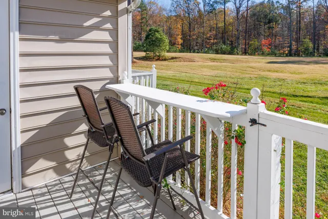a view of a patio with two chairs and a table