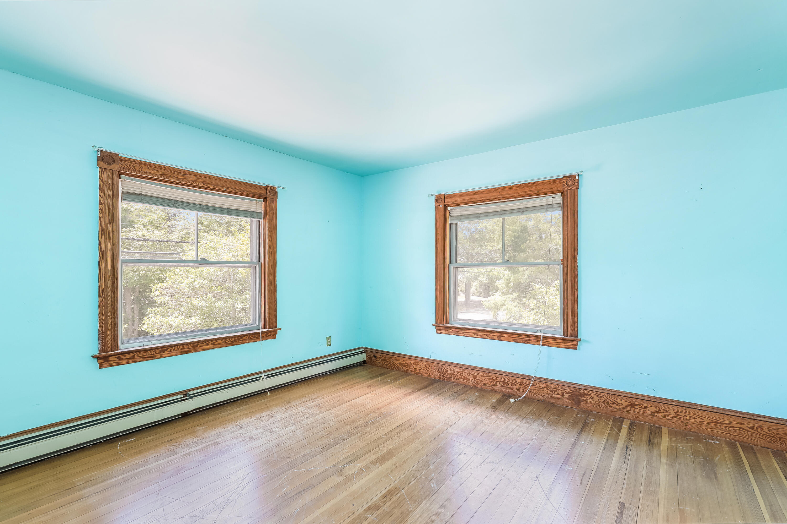 1021 Sandwich Road Sagamore, MA 02561 - Photo 14 of 18 an empty room with wooden floor and windows