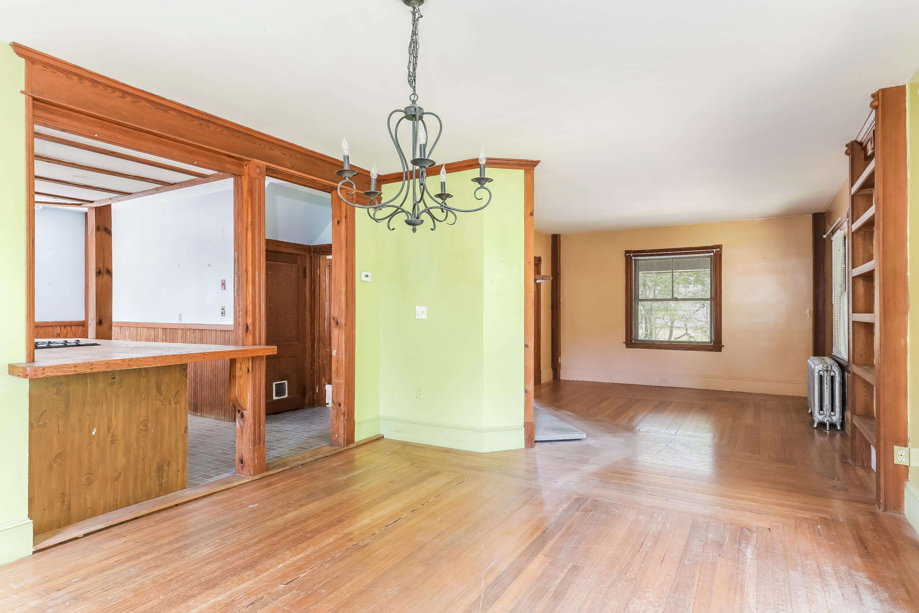 1021 Sandwich Road Sagamore, MA 02561 - Photo 5 of 18 a view of a hallway with wooden floor and a kitchen