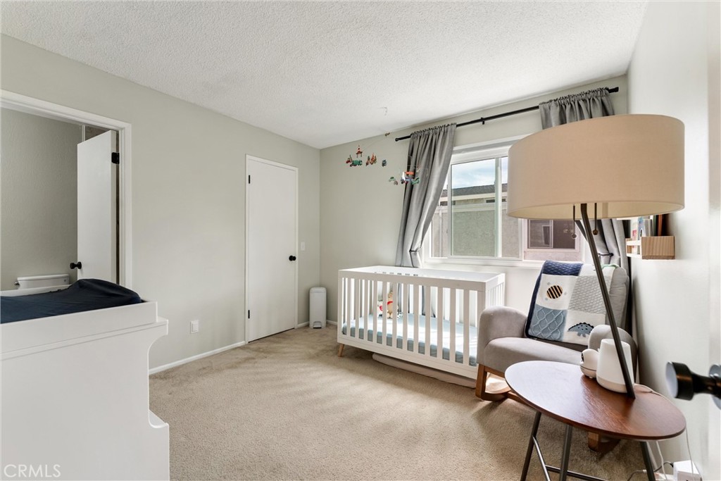 19431 Sherman Way, Unit 24 Reseda, CA 91335 - Photo 13 of 26 a bedroom with furniture and a window
