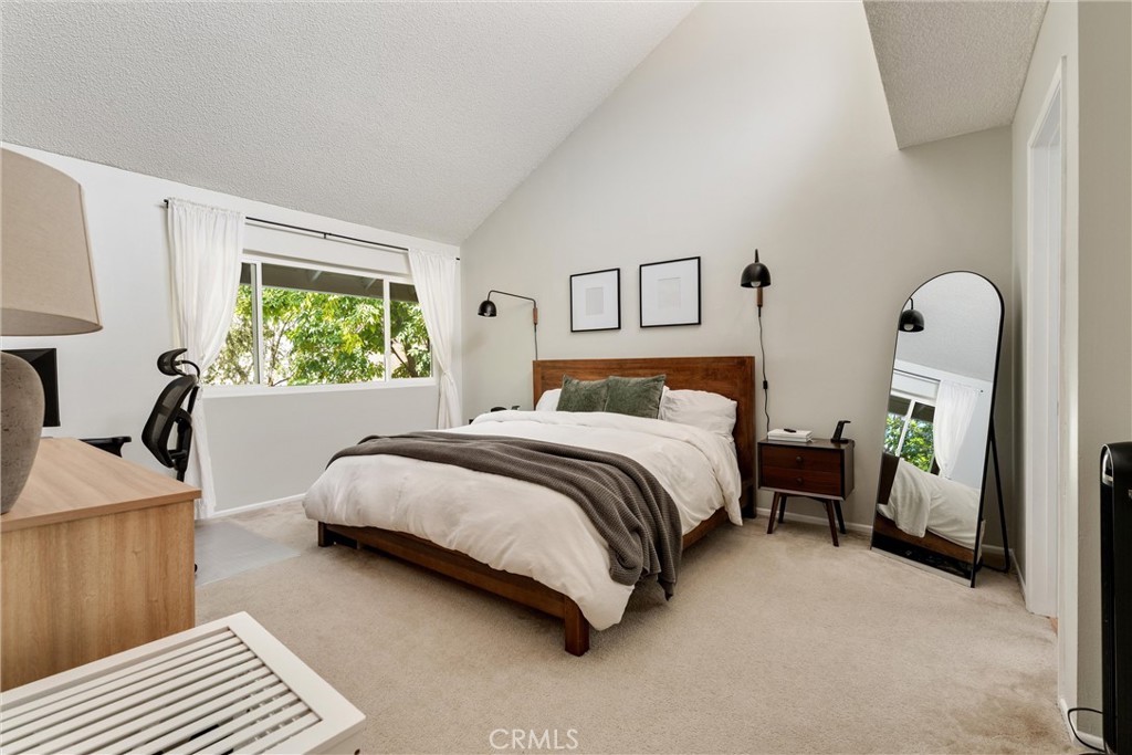 19431 Sherman Way, Unit 24 Reseda, CA 91335 - Photo 15 of 26 a bedroom with a bed and a night stand