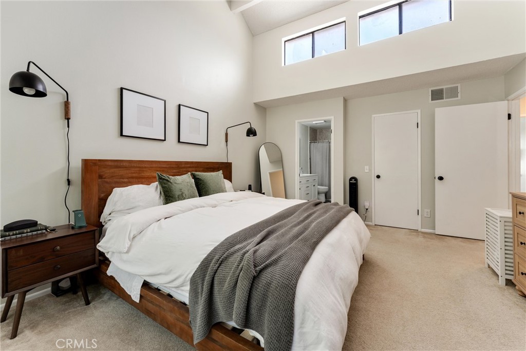 19431 Sherman Way, Unit 24 Reseda, CA 91335 - Photo 16 of 26 a spacious bedroom with a bed and a cabinets