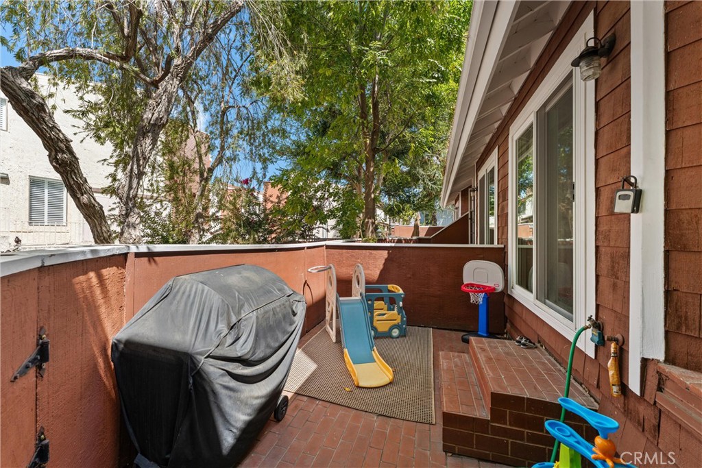 19431 Sherman Way, Unit 24 Reseda, CA 91335 - Photo 2 of 26 a view of roof deck with dining table and chairs