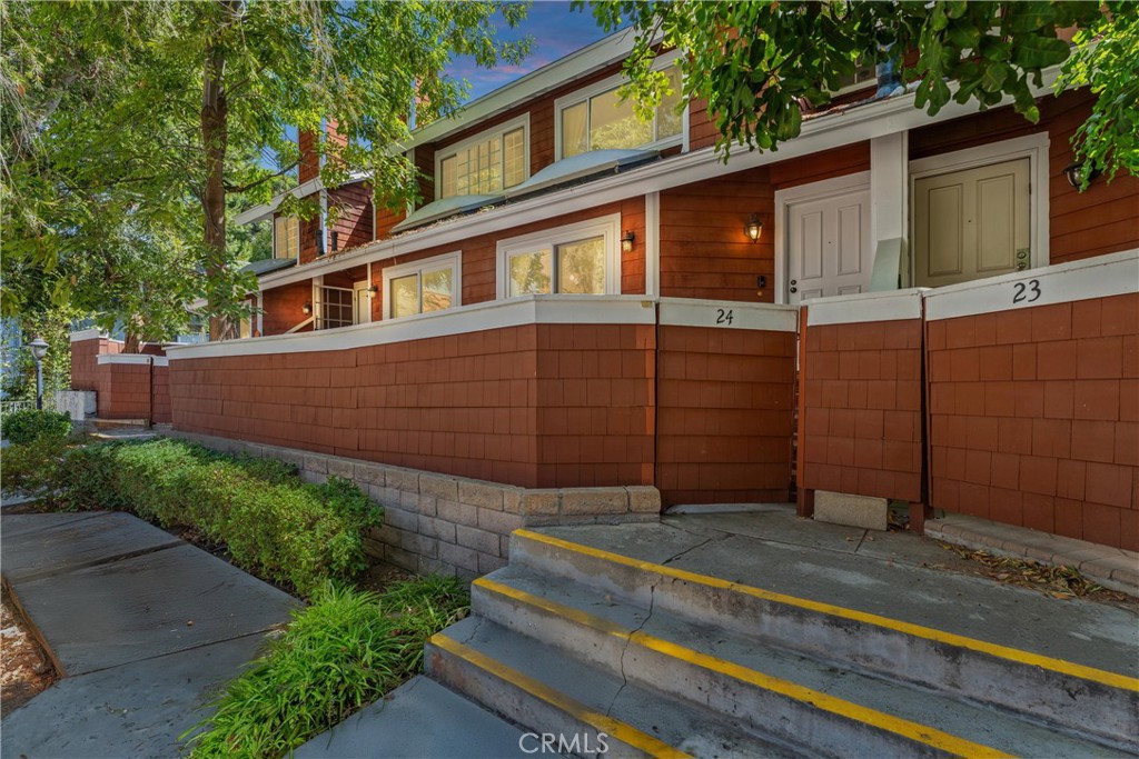 19431 Sherman Way, Unit 24 Reseda, CA 91335 - Photo 23 of 26 a front view of a house with a garden