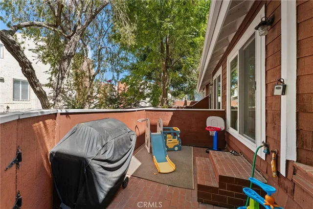 a view of roof deck with chair and wooden fence