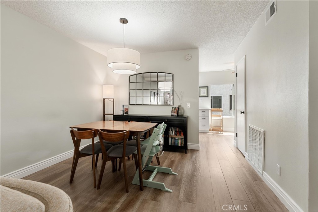 19431 Sherman Way, Unit 24 Reseda, CA 91335 - Photo 6 of 26 a view of a dining room with furniture and wooden floor
