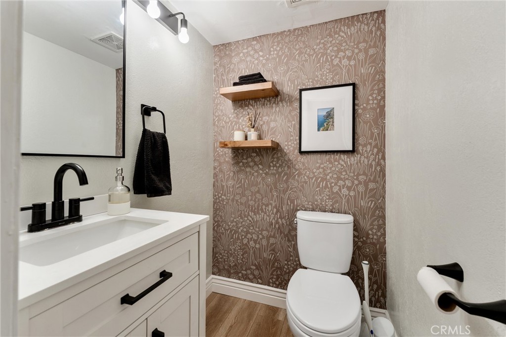 19431 Sherman Way, Unit 24 Reseda, CA 91335 - Photo 7 of 26 a bathroom with a toilet sink and mirror