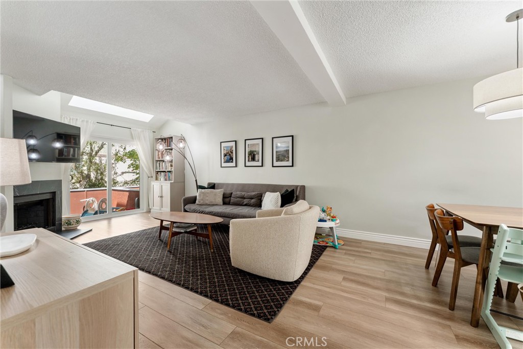 19431 Sherman Way, Unit 24 Reseda, CA 91335 - Photo 8 of 26 a living room with furniture and a fireplace