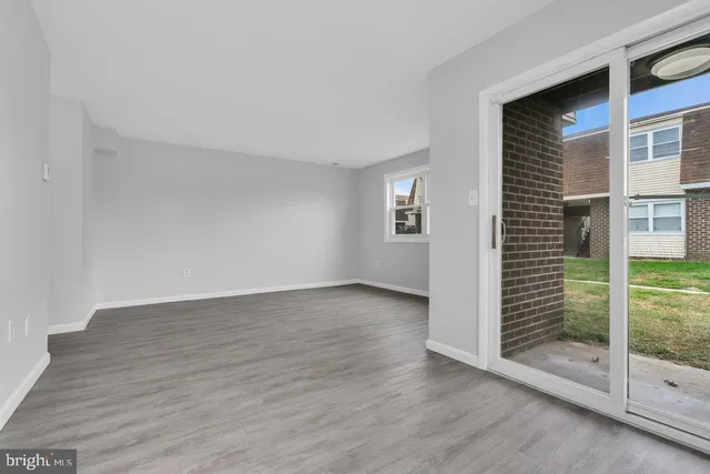 a view of wooden floor and windows in a room