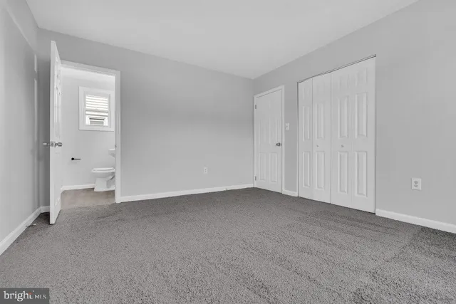 a view of an empty room and closet area