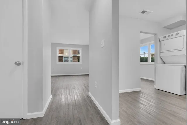 a view of hallway with wooden floor