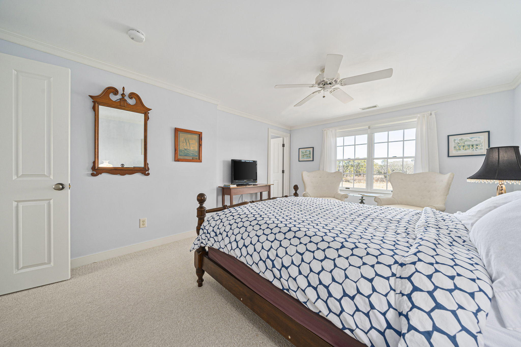 46 Lookout Road Yarmouth Port, MA 02675 - Photo 31 of 49 a bedroom with a large bed and a chandelier