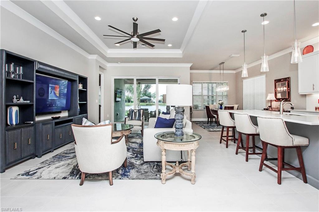 11857 Hydrangea Place Naples, FL 34120 - Photo 13 of 50 a living room with lots of furniture and kitchen view