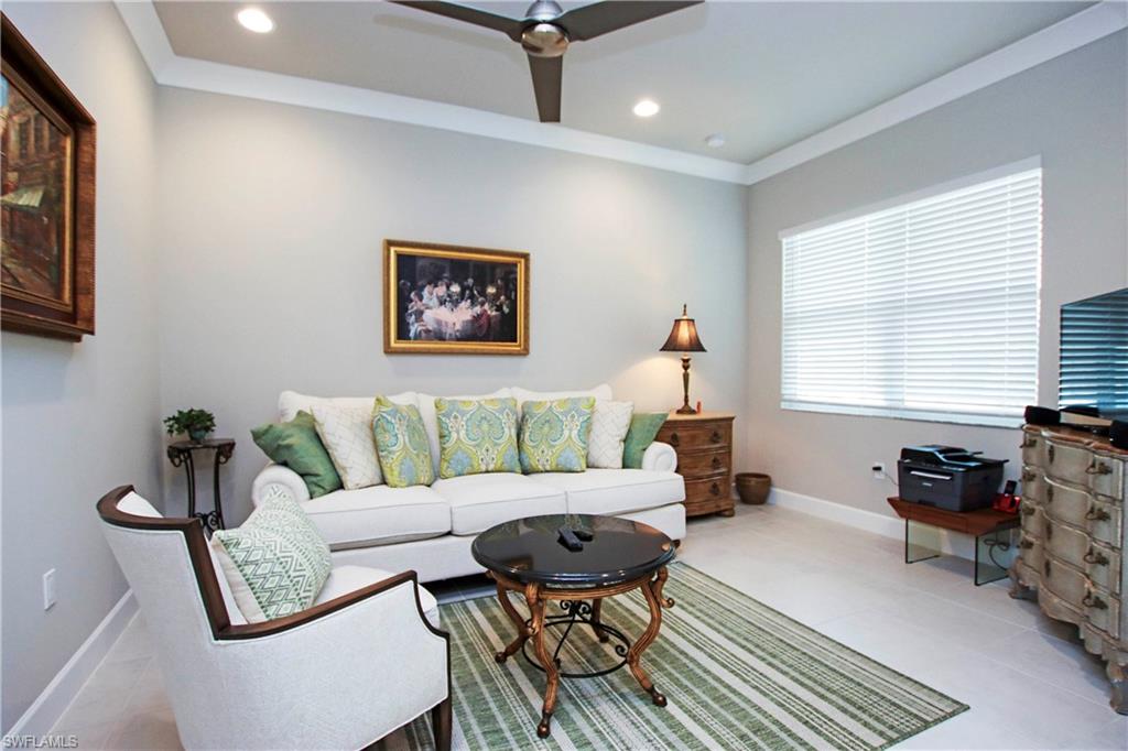 11857 Hydrangea Place Naples, FL 34120 - Photo 14 of 50 a living room with furniture a window and a table