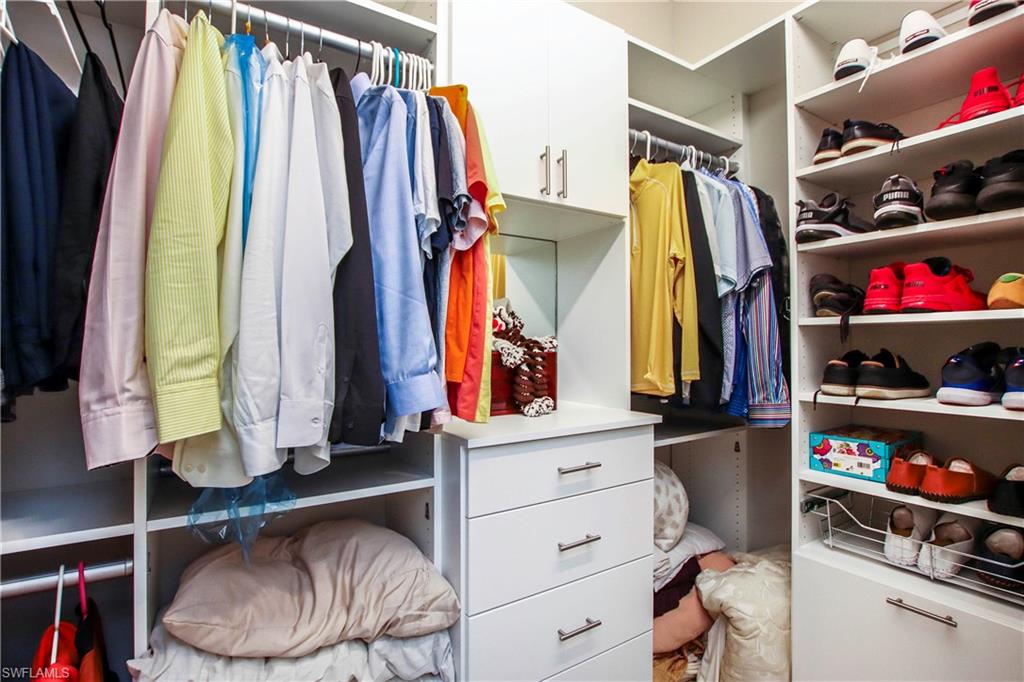 11857 Hydrangea Place Naples, FL 34120 - Photo 18 of 50 a view of walk in closet with clothes and shoes