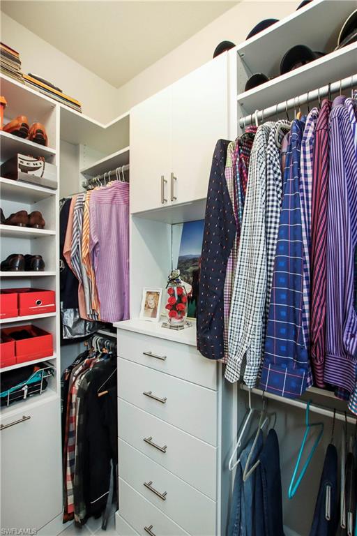 11857 Hydrangea Place Naples, FL 34120 - Photo 19 of 50 a view of walk in closet with clothes and shoes
