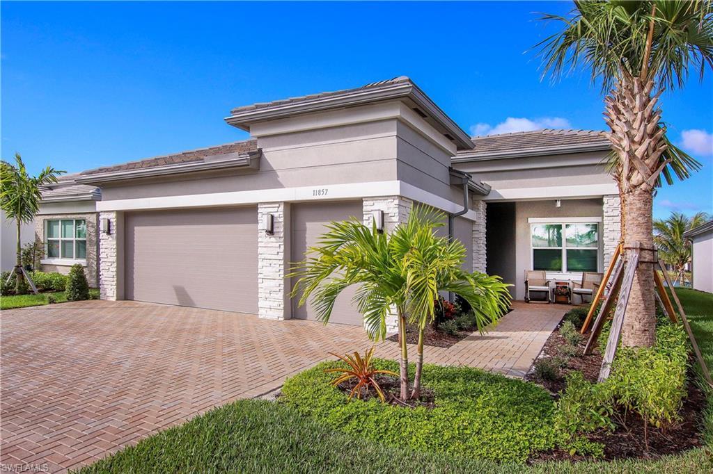 11857 Hydrangea Place Naples, FL 34120 - Photo 2 of 50 a front view of house with yard and green space