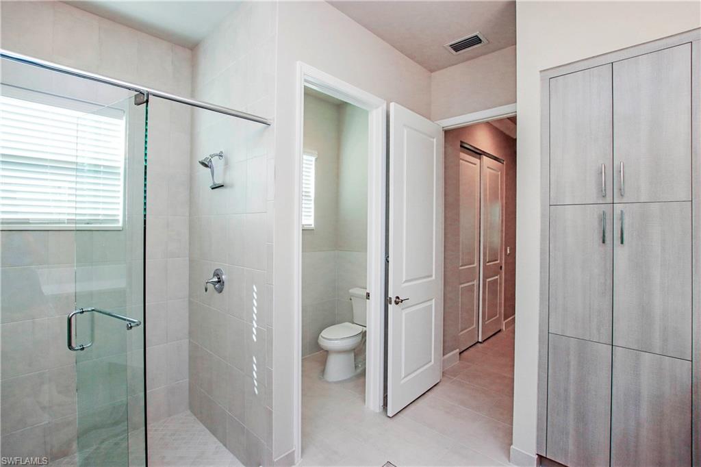 11857 Hydrangea Place Naples, FL 34120 - Photo 22 of 50 a bathroom with a shower and a toilet