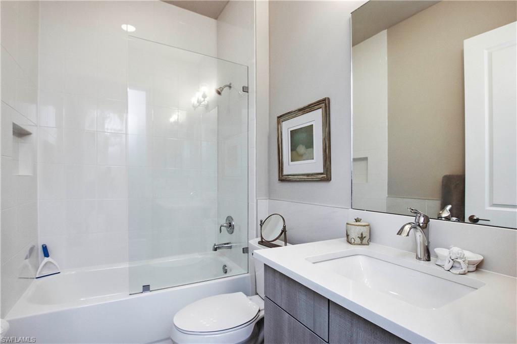11857 Hydrangea Place Naples, FL 34120 - Photo 26 of 50 a bathroom with a granite countertop sink toilet and shower