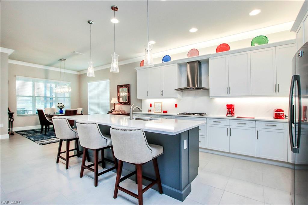 11857 Hydrangea Place Naples, FL 34120 - Photo 31 of 50 a kitchen with a sink and cabinets