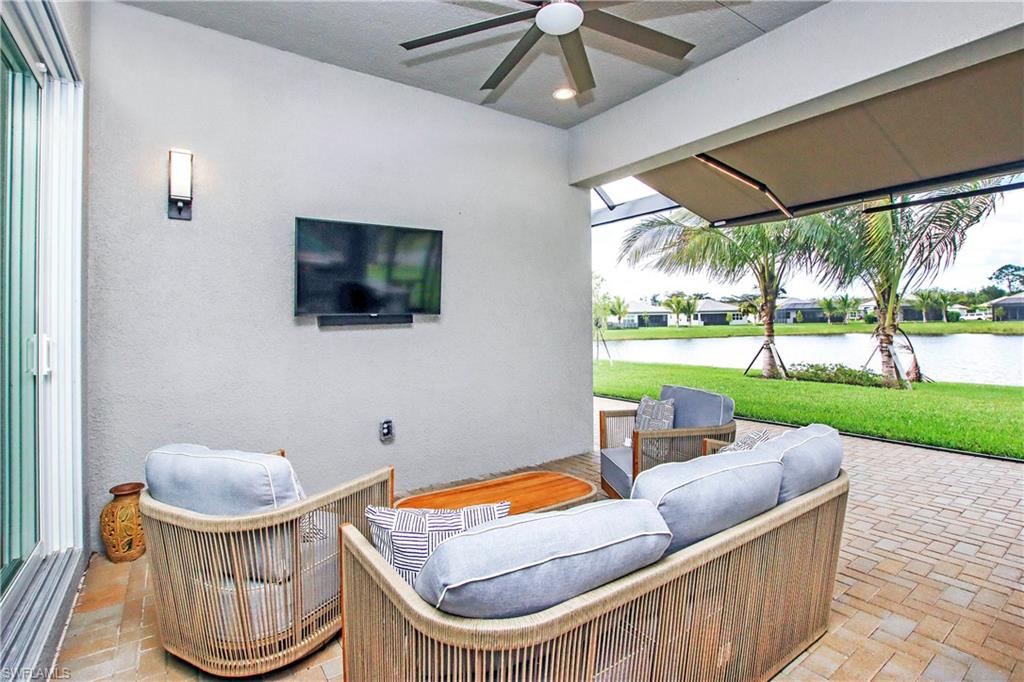 11857 Hydrangea Place Naples, FL 34120 - Photo 34 of 50 a living room with a couch and a table
