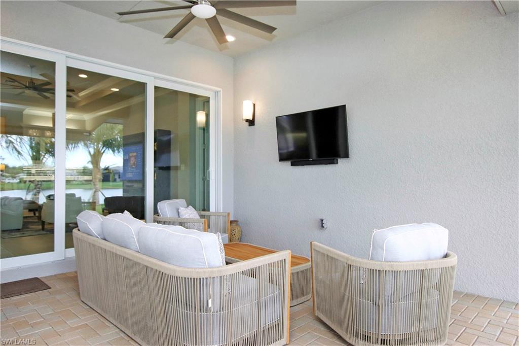 11857 Hydrangea Place Naples, FL 34120 - Photo 35 of 50 a living room with furniture and a flat screen tv