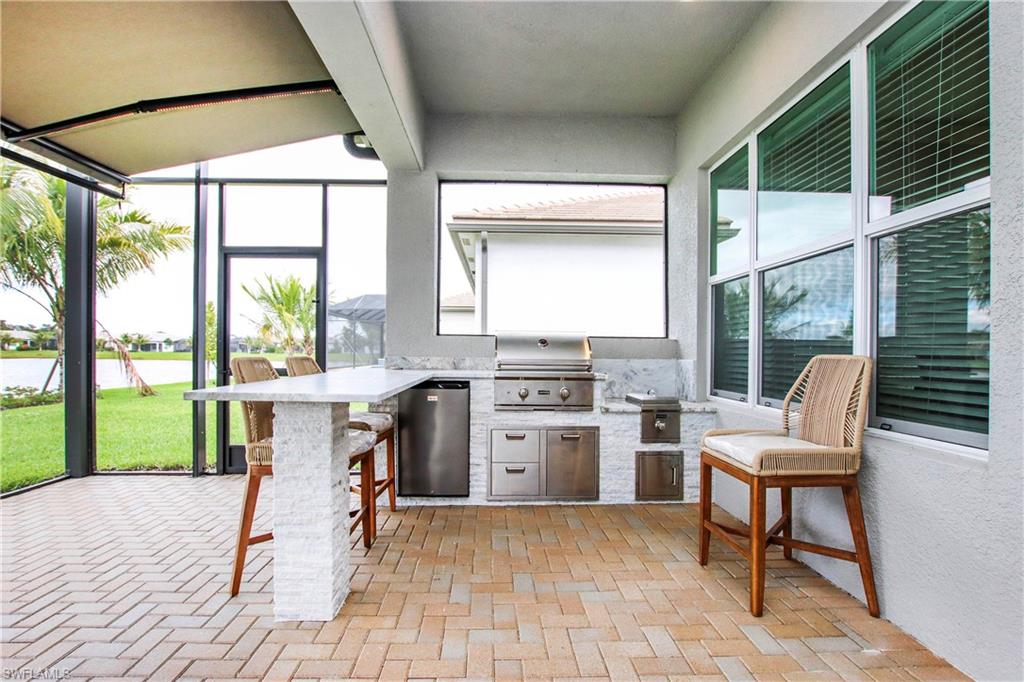 11857 Hydrangea Place Naples, FL 34120 - Photo 37 of 50 a room with furniture a large window and a rug