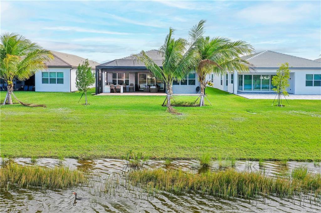 11857 Hydrangea Place Naples, FL 34120 - Photo 38 of 50 a view of a house with a yard