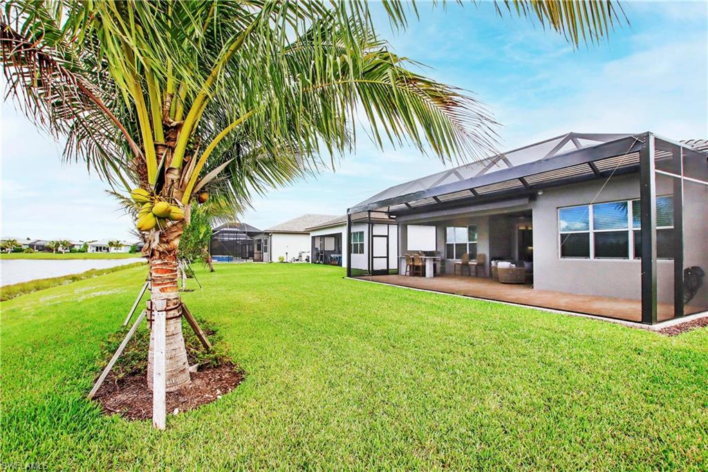 11857 Hydrangea Place Naples, FL 34120 - Photo 40 of 50 a view of a house with a yard and sitting area