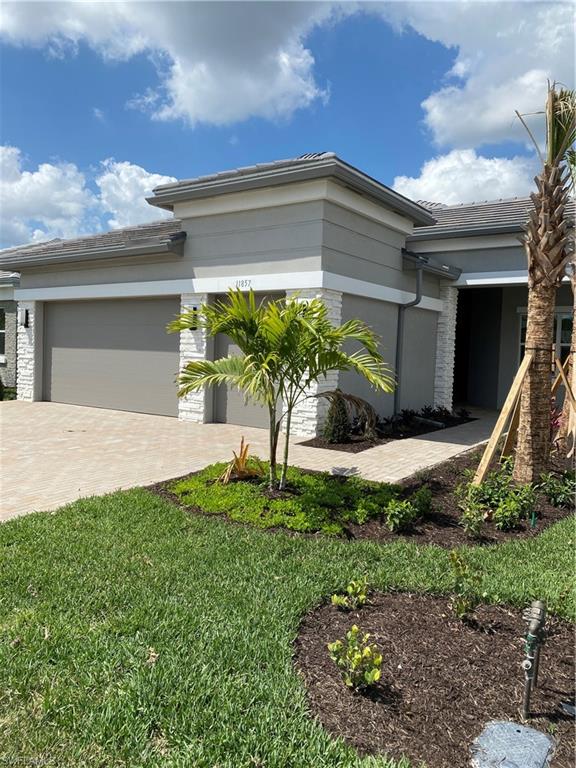 11857 Hydrangea Place Naples, FL 34120 - Photo 4 of 50 a front view of a house with garden