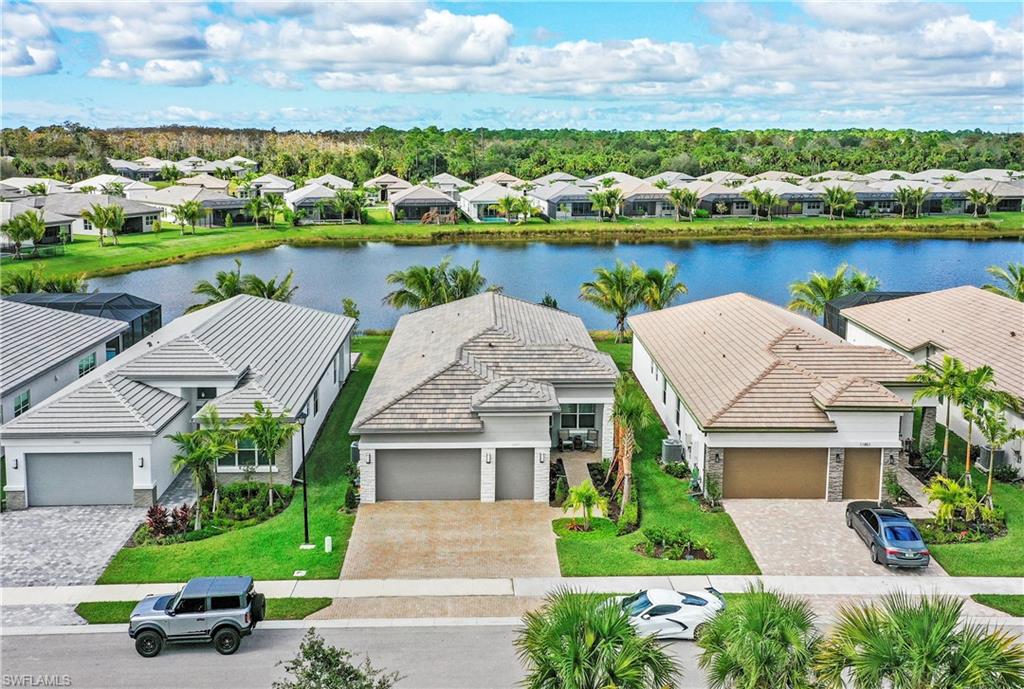 11857 Hydrangea Place Naples, FL 34120 - Photo 45 of 50 an aerial view of house with yard and lake view