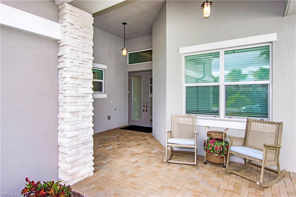 11857 Hydrangea Place Naples, FL 34120 - Photo 5 of 50 a living room with furniture and a potted plant