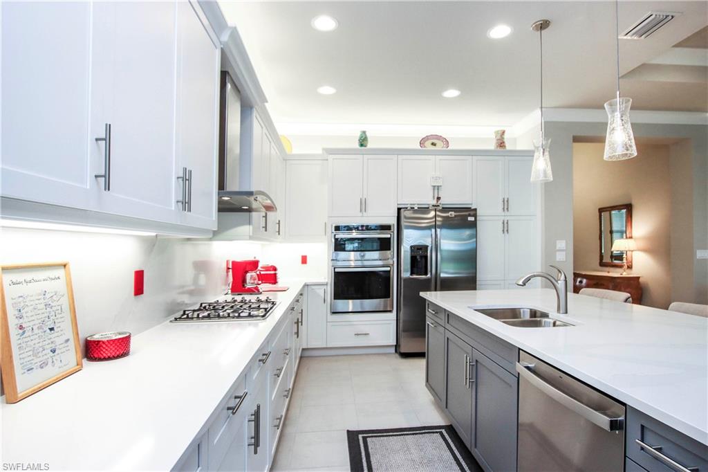 11857 Hydrangea Place Naples, FL 34120 - Photo 7 of 50 a kitchen with kitchen island stainless steel appliances cabinets a sink and a counter top