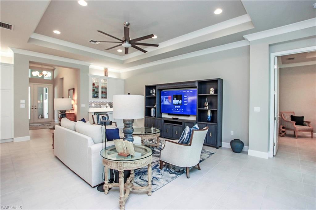 11857 Hydrangea Place Naples, FL 34120 - Photo 10 of 50 a living room with furniture and a flat screen tv