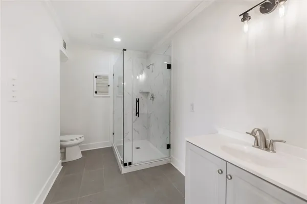 a bathroom with a toilet sink and shower