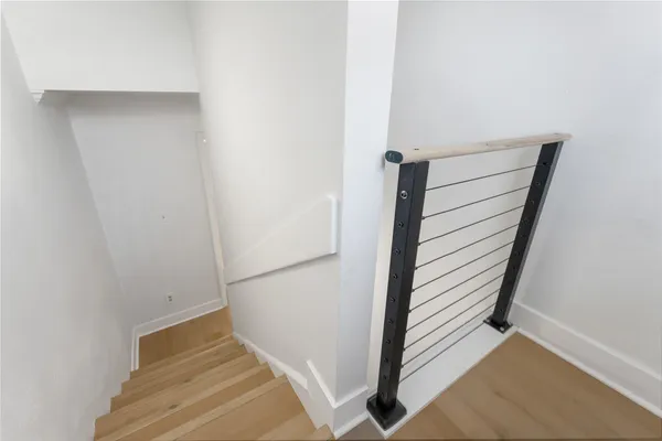 a view of staircase with white walls and stairs
