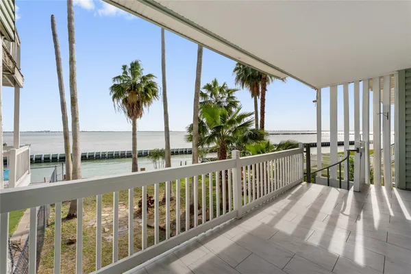 a view of a balcony with potted plants