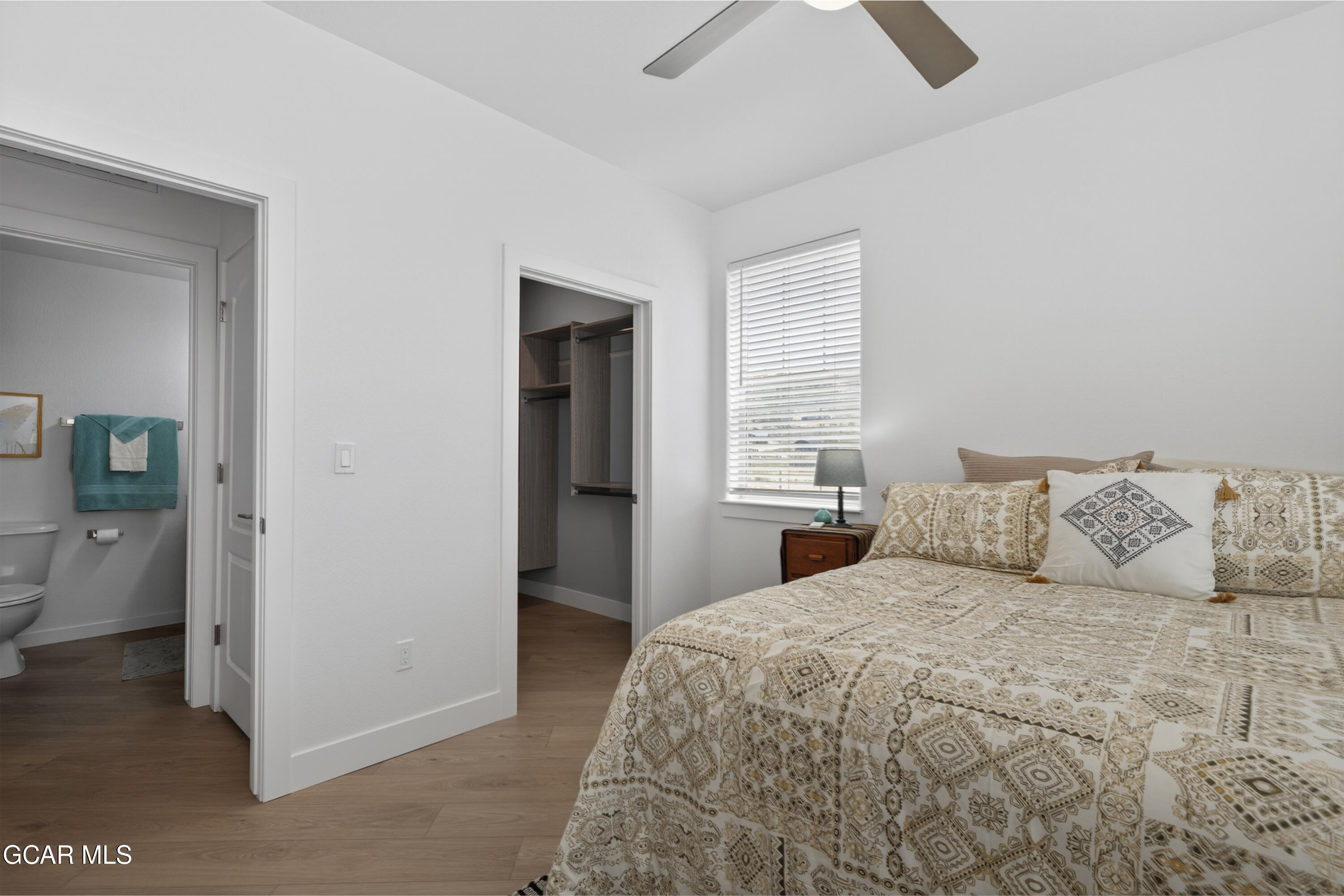 160 Village Road, Unit F207 Granby, CO 80446 - Photo 14 of 28 a bedroom with a large bed and a chandelier