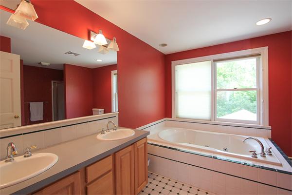 17 Old Rubbly Road Beverly, MA 01915 - Photo 10 of 17 a bathroom with a bathtub a double vanity sink and a large mirror