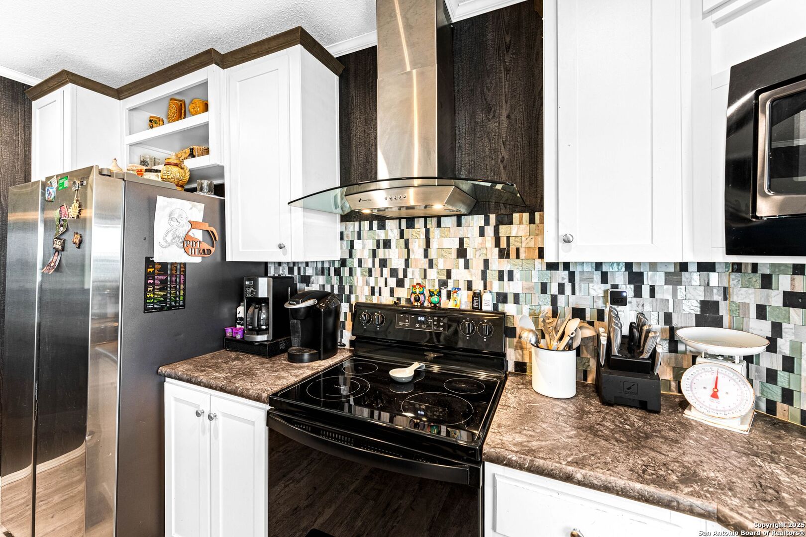 1979 County Road 651 Devine, TX 78016 - Photo 12 of 52 a kitchen with appliances a sink and cabinets