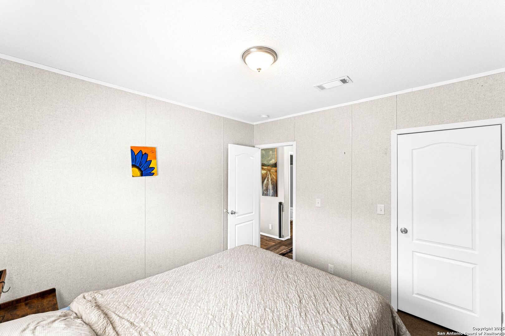 1979 County Road 651 Devine, TX 78016 - Photo 16 of 52 a bedroom with a bed and a book shelf